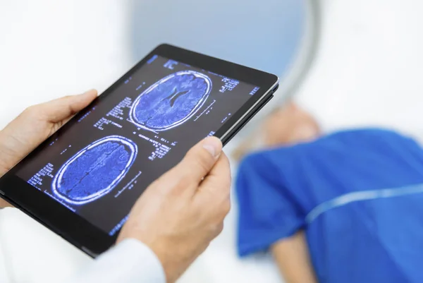 Radiologic technician and Patient being scanned and diagnosed on