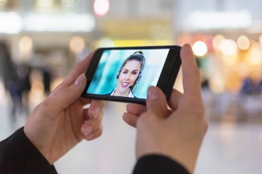 bir akıllı telefon sırasında bir skype video tutan bir kadın eli yakın çekim