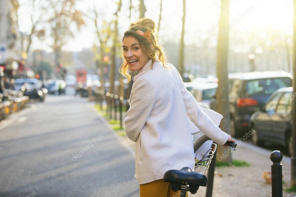 Young woman riding bicycle in Paris