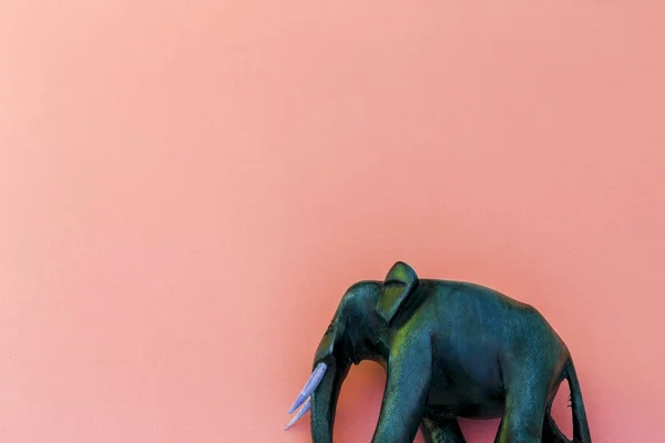Wooden elephant on purple background