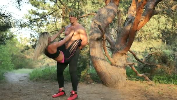Sport couple in a pine forest — Stock Video