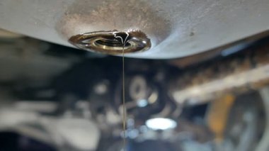 the exhausted oil flows out of the engine carter
