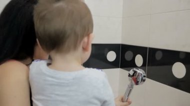 Mom with a small child in the bathroom