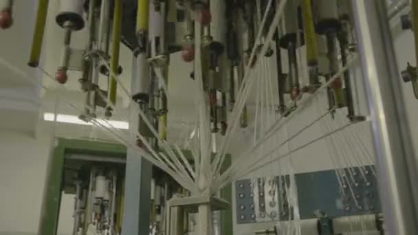 Spinning clews with threads on a rack at a textile plant. — Stock Video