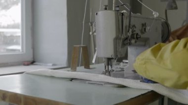 Work behind a sewing machine in a textile factory of non-horny fabric
