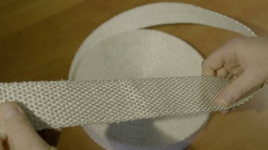 Erkeklerin elleri eğri büğrü, yanıcı olmayan bir kumaşı tutar.