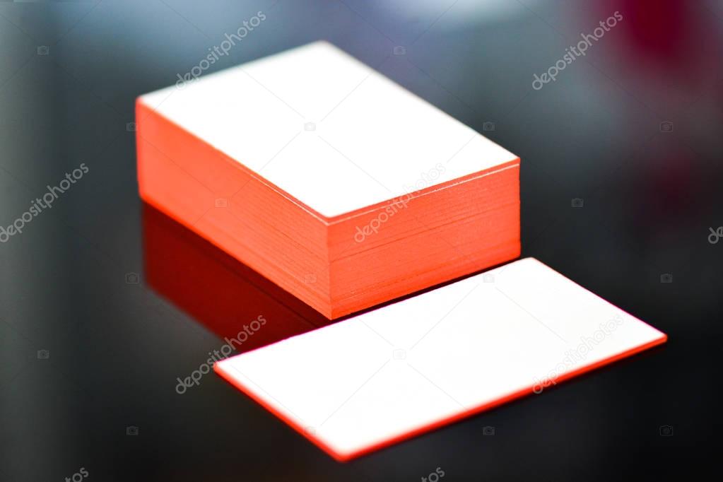thick white cotton paper business card mock up with red painted edges. Blank business cards template.