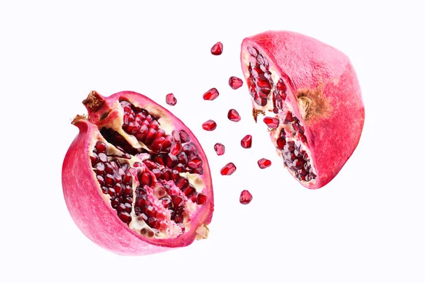 Pomegranate in flight burst on a white background, isolated. Cut half pomegranate flying in the air. Pomegranate fruit explosion — Stock Photo, Image