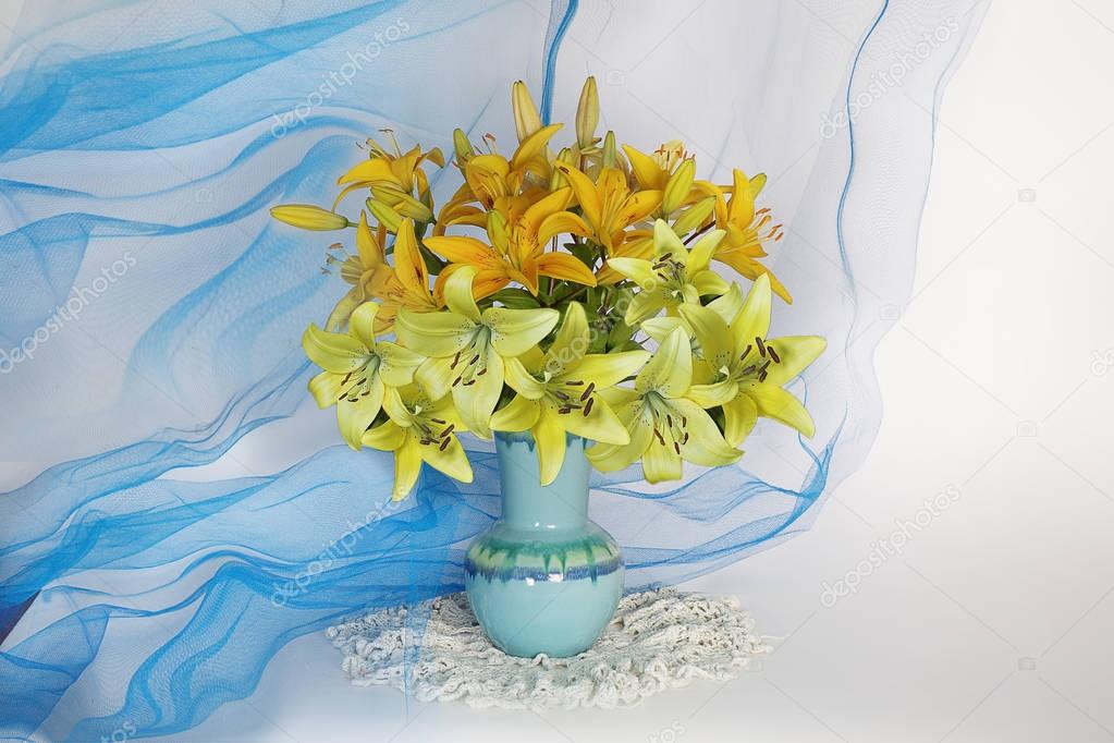 Still life with a bouquet of lilies in a blue vase.