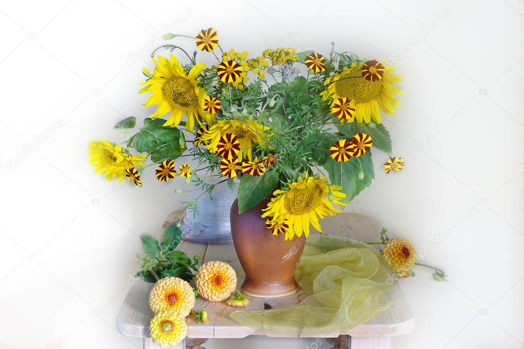 A beautiful bouquet of sunflowers , marigolds and dahlias