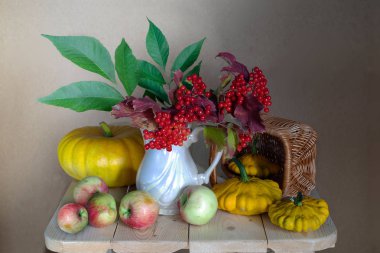 Sonbahar natürmort kabak, elma, çilek ile kahverengi bir arka plan üzerinde .