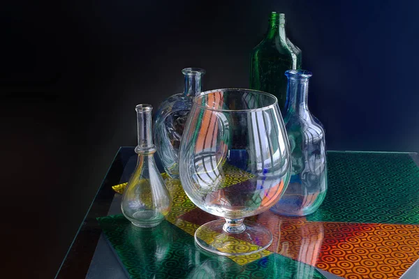 Glass Vases Bottles Interestingly Lie Windowsill Isolated Dark Background — Stock Photo, Image