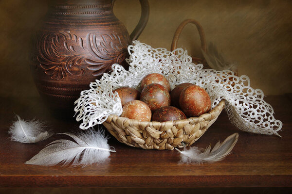 Easter still life with beautiful eggs on an openwork napkin .