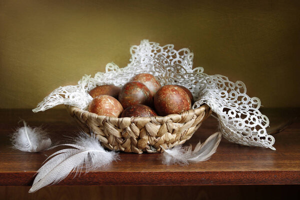 Easter still life with beautiful eggs on an openwork napkin .