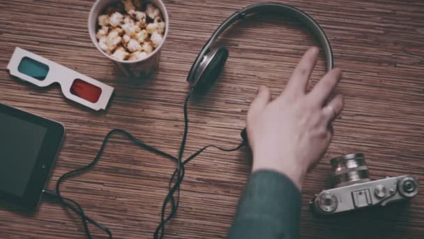 Cinema and Entertainment Concept, Man takes headphones, Top view — Stock Video