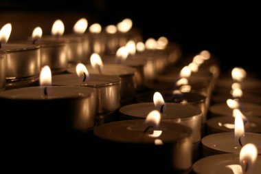 Many small candles in the dark