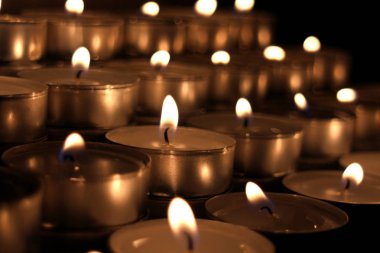 Many small candles in the dark