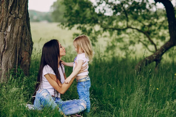 Barn nära träd med mamma — Stockfoto