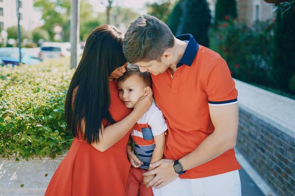 Hermosa familia en rojo caminando por la calle y el Parque —  Fotos de Stock