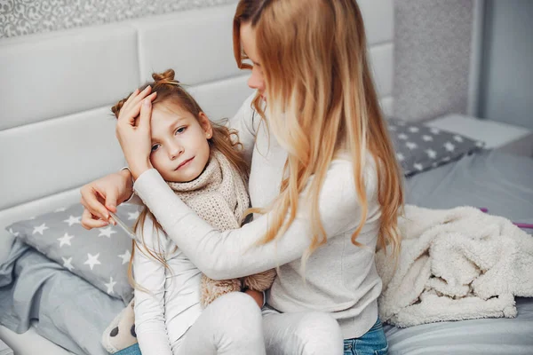 Mother with her illnes daughter in a bedroom — Stock Photo, Image