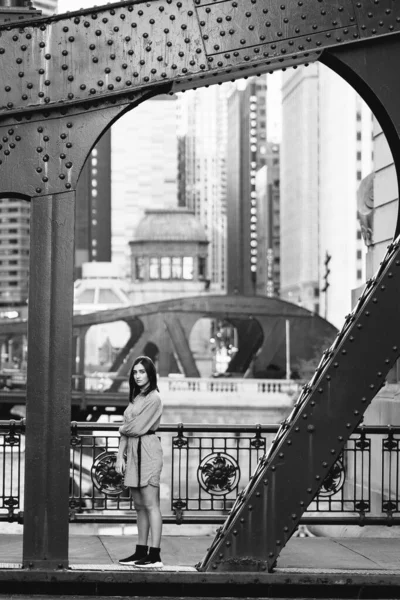 young lady crossing the bridge in the city