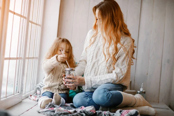 Mother and daughter by the window — Stock Photo, Image