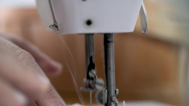 Person using white sewing machine in garment factory — Stock Video