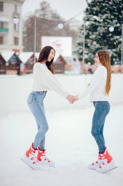 Cute and beautiful girls in a white sweater in a winter city — Stock Photo, Image