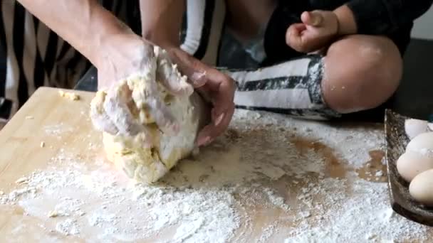 Closeup of process of kneading dough on wooden table in kitchen — Stock Video