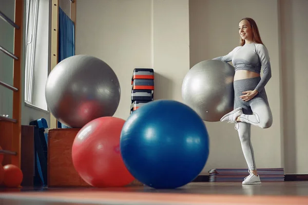 Беременная женщина тренируется в спортзале — стоковое фото
