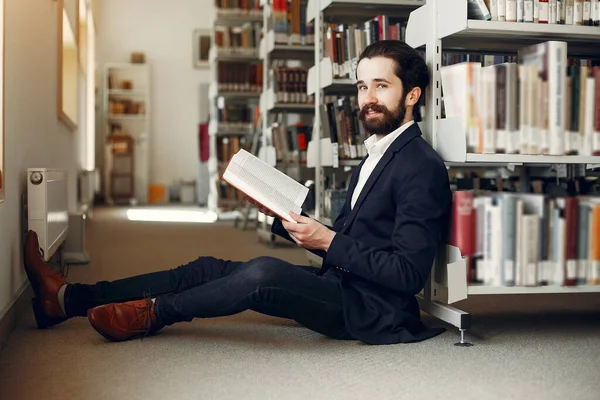 Ο όμορφος τύπος μελετά στη βιβλιοθήκη — Φωτογραφία Αρχείου