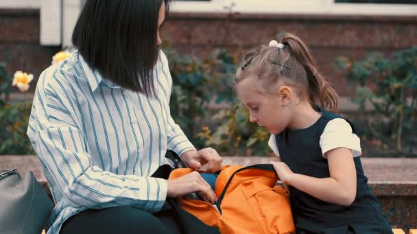 Madre e figlia europee stanno sistemando un kit scolastico — Video Stock