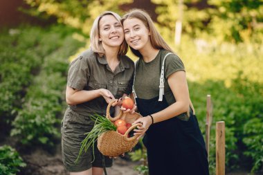 Beautiful family works in a garden near the house