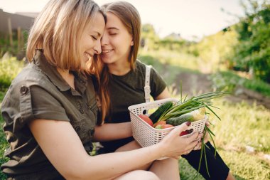 Beautiful family works in a garden near the house