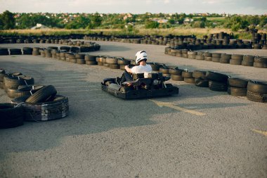 Handsome man in a karting with a car