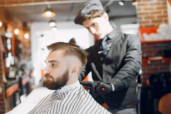 Elegante hombre sentado en una barbería —  Fotos de Stock