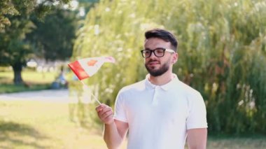 Genç adam Kanada bayrağını sallıyor.