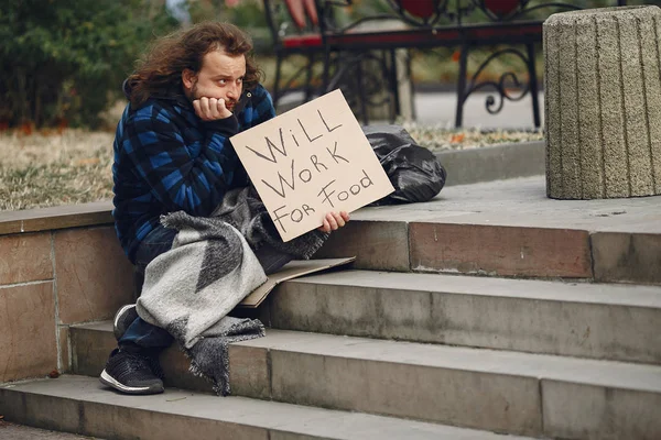 Bezdomovec v odolném oblečení podzimní město — Stock fotografie