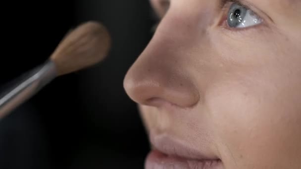 Closeup of female face while doing makeup in salon — Stock Video