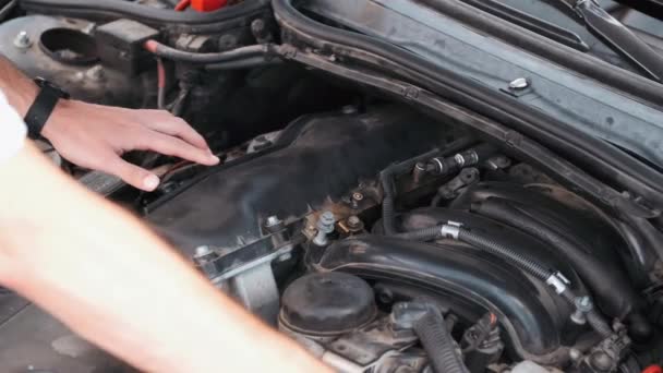 Closeup of process of repairing car by person at gas station — 비디오