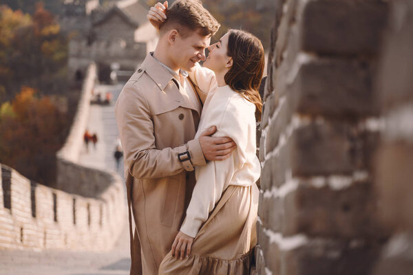 beautiful young couple hugging at the Great Wall of China