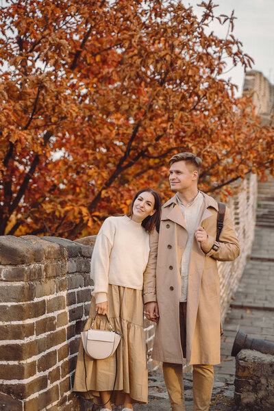 young couple kissing at the Great Wall of China