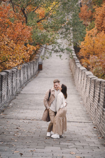 young couple kissing at the Great Wall of China