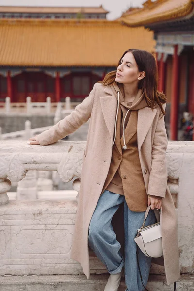 stylish girl visiting the forbidden city in Beijing China