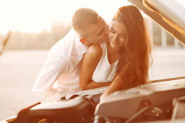 Mooi koppel brengt tijd door in een zomerpark vlakbij een auto — Stockfoto