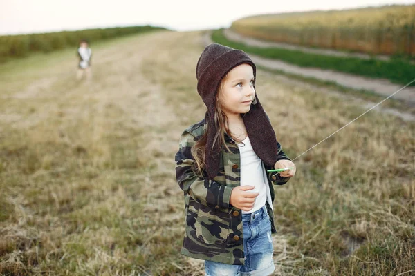 Schattig klein kind in een zomer veld met een vlieger — Stockfoto