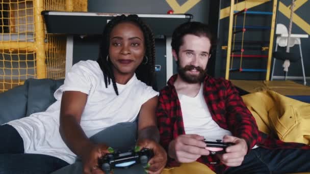 Portrait of African American woman and bearded man with joysticks — Stock Video