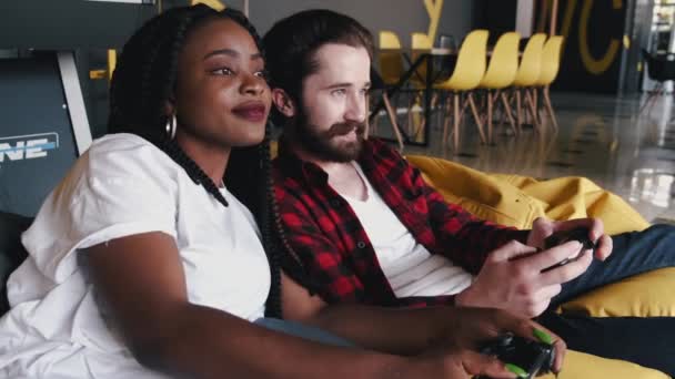 Portrait of African American woman and bearded man with joysticks — Stock Video