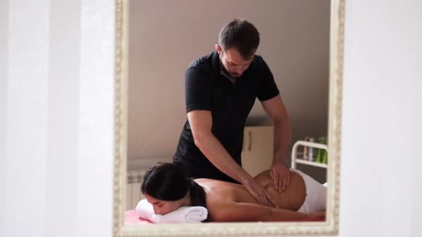 Masajista haciendo masaje de mujeres de vuelta en el salón — Vídeo de stock