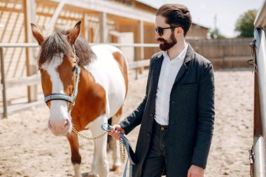 Çiftlikte duran eli olan adam.